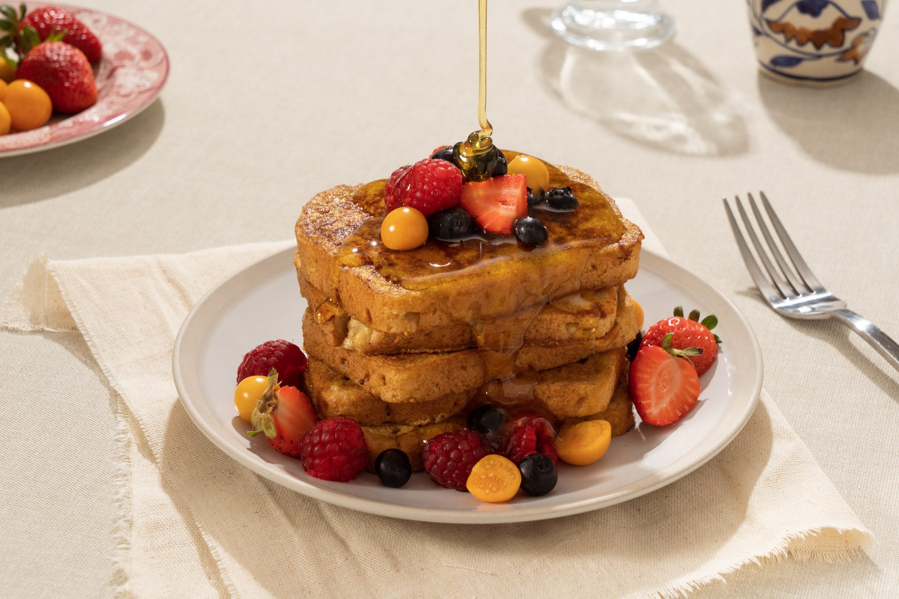 Torre de tostadas francesas hechas con pan True Food, con frutos rojos y miel