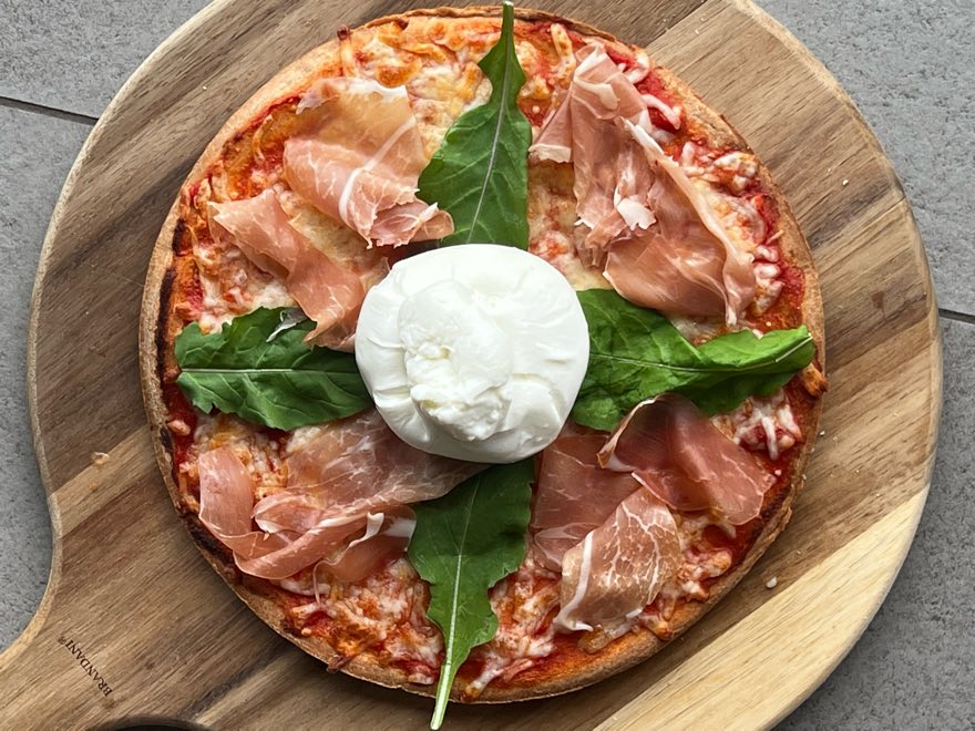 Baked pizza on a wooden board